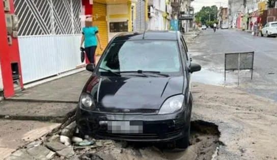 Imagem de Carro afunda em cratera após asfalto ceder, em cidade do interior; saiba mais